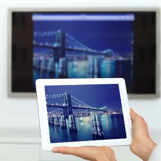 Woman using digital tablet with SmartTV image